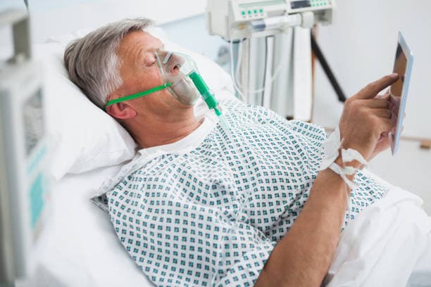 Patient receiving IV medication with nurse monitoring